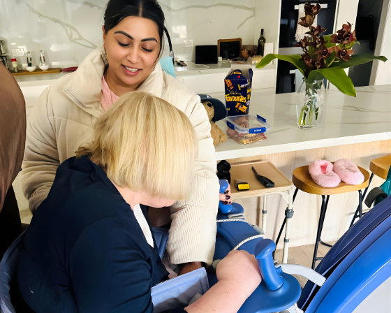 Child in wheelchair interacting with caregiver